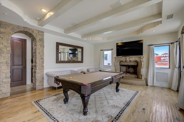 game room with beam ceiling, billiards, light hardwood / wood-style floors, and plenty of natural light