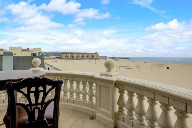 exterior space featuring a water view and a view of the beach