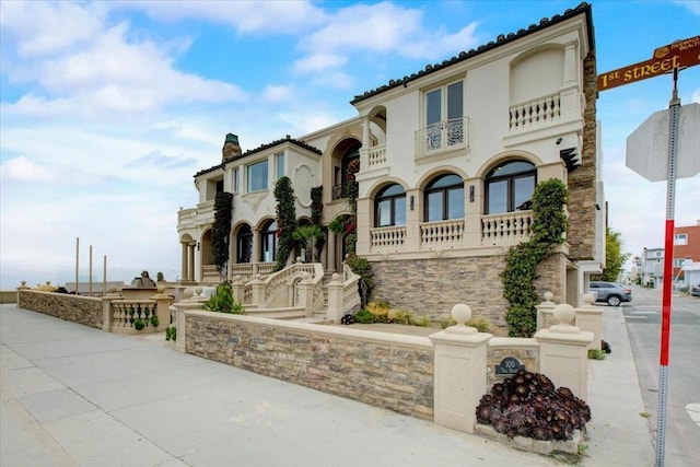 mediterranean / spanish-style house with a balcony