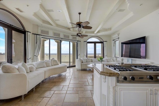 interior space with french doors, beam ceiling, stainless steel gas stovetop, and white cabinets