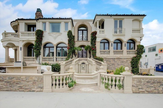 mediterranean / spanish-style home featuring a balcony