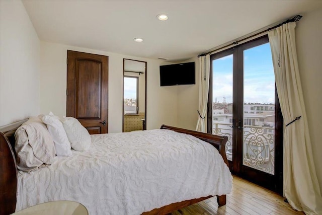 bedroom with french doors and light wood-type flooring