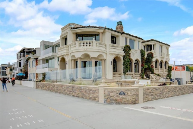 mediterranean / spanish-style home featuring a balcony