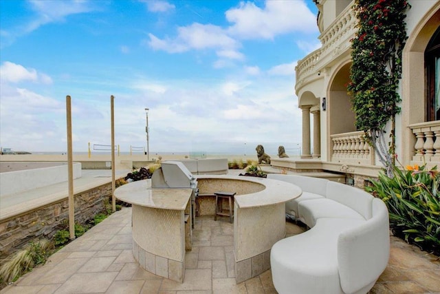 view of patio with an outdoor kitchen and exterior bar