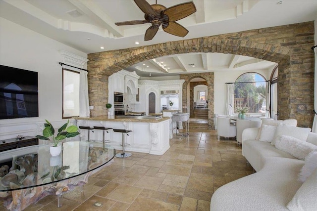 living room featuring beam ceiling and ceiling fan