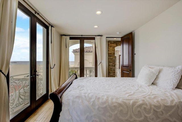 bedroom featuring french doors, light wood-type flooring, and access to exterior