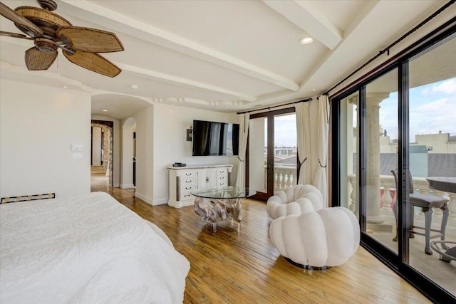 bedroom with hardwood / wood-style flooring, access to outside, and ceiling fan