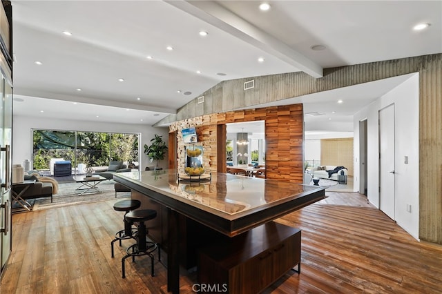 bar featuring vaulted ceiling with beams and wood-type flooring