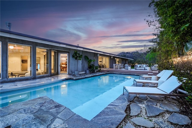 view of pool at dusk