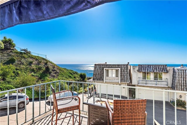 balcony featuring a water view