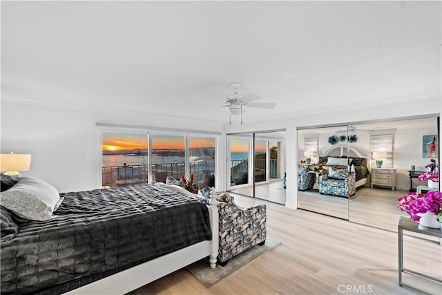 bedroom with ceiling fan, ornamental molding, wood-type flooring, and access to outside