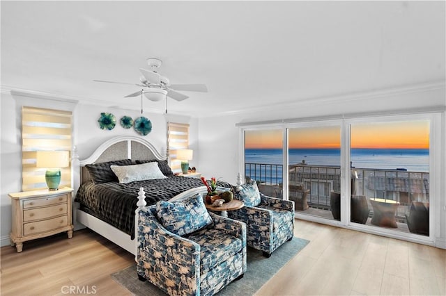 bedroom with a water view, wood-type flooring, access to outside, ornamental molding, and ceiling fan