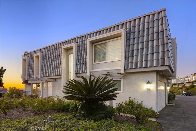 property exterior at dusk with a garage