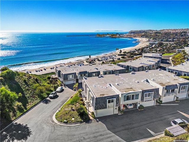 drone / aerial view featuring a water view and a view of the beach