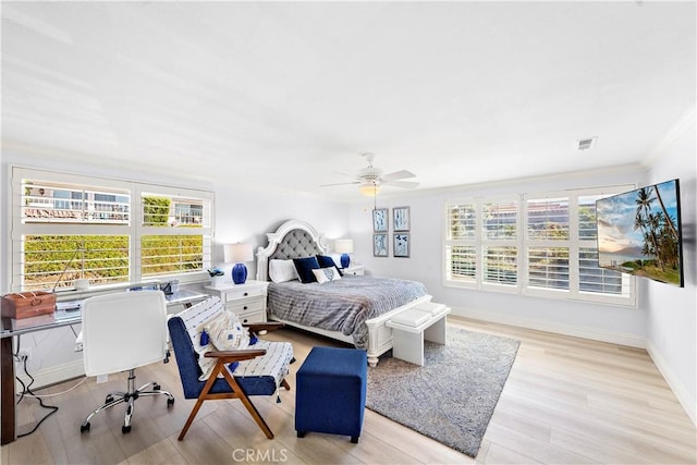 bedroom featuring ornamental molding, ceiling fan, and light hardwood / wood-style floors