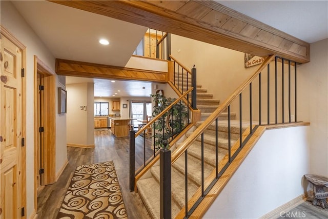 staircase with hardwood / wood-style flooring