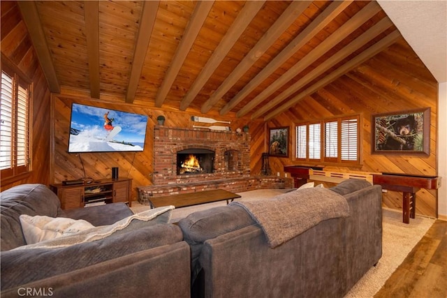 living room featuring a fireplace, wooden ceiling, wooden walls, and vaulted ceiling with beams