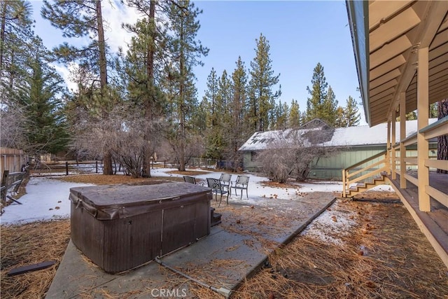 yard covered in snow featuring a hot tub