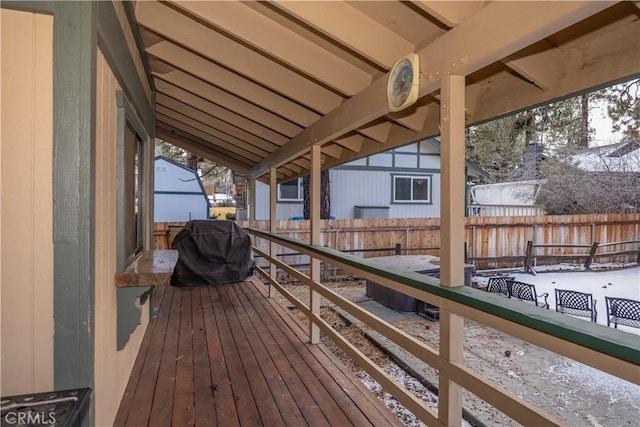 snow covered deck featuring a grill