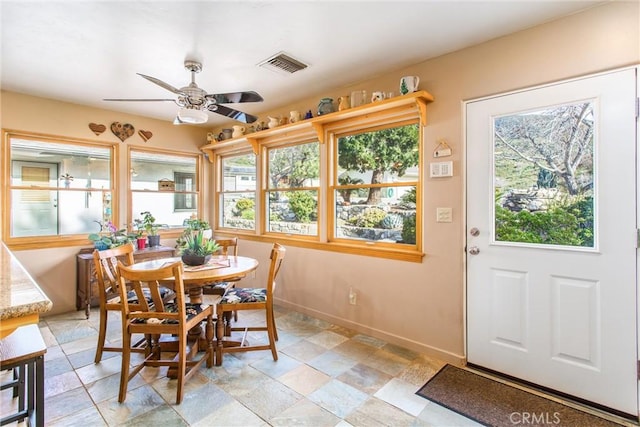 dining room featuring visible vents, ceiling fan, and baseboards