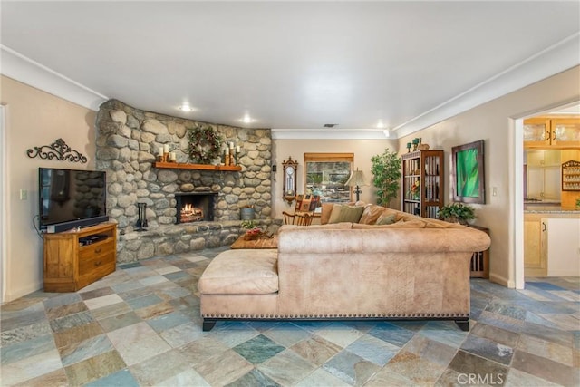 living room with stone finish flooring, a stone fireplace, and baseboards