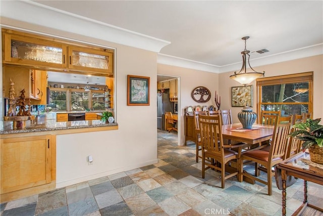 dining area featuring stone finish floor, visible vents, and baseboards