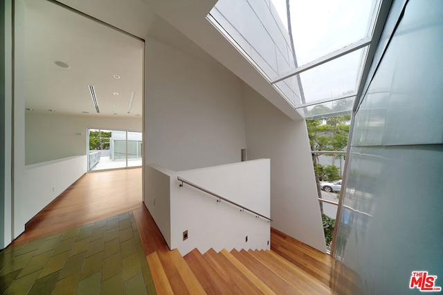 interior space featuring a skylight and wood-type flooring