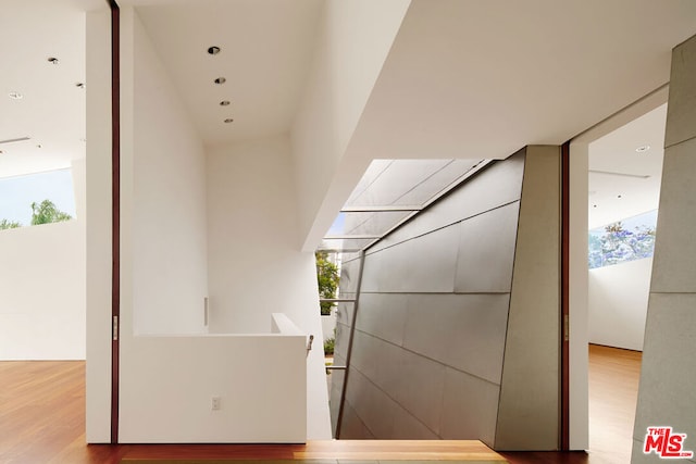 interior space with plenty of natural light and hardwood / wood-style floors