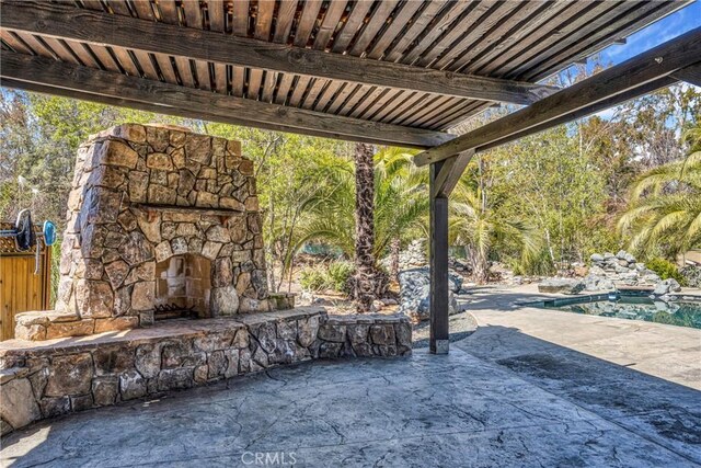 view of patio with an outdoor stone fireplace