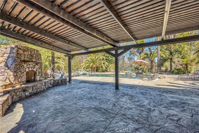 view of patio featuring an outdoor stone fireplace