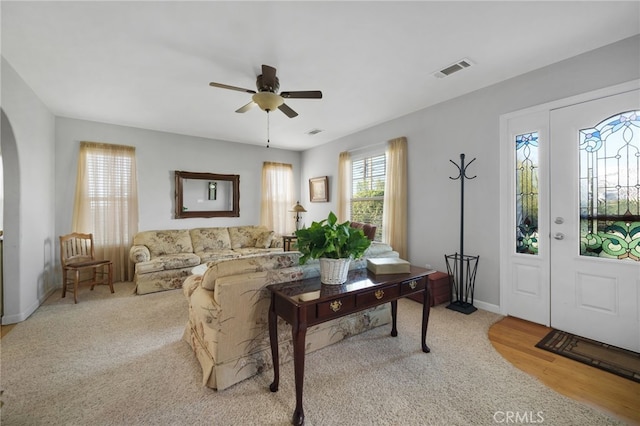 living room with ceiling fan and light hardwood / wood-style floors