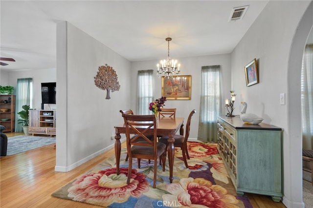 dining space featuring a notable chandelier and wood-type flooring