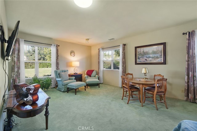 interior space featuring plenty of natural light and light carpet