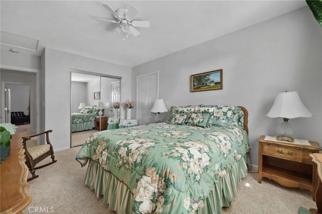 carpeted bedroom with a closet and ceiling fan