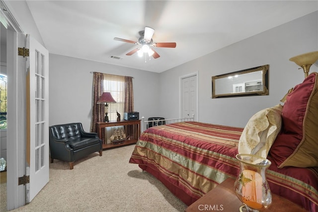 bedroom with light carpet and ceiling fan