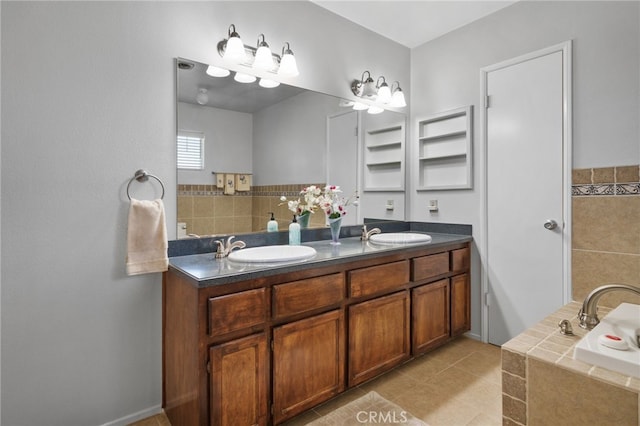 bathroom with a bath, vanity, and tile patterned floors