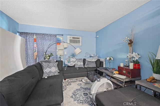 living room with a textured ceiling and a wall mounted air conditioner