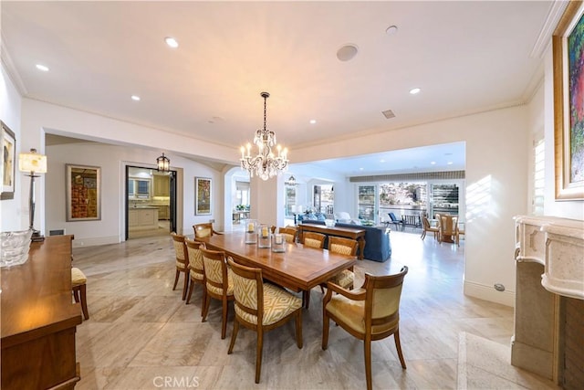 dining space featuring an inviting chandelier and ornamental molding