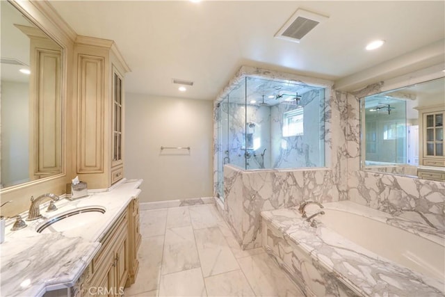 bathroom featuring vanity and shower with separate bathtub