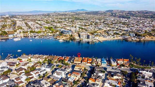 drone / aerial view with a water and mountain view