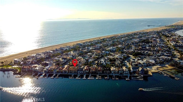 drone / aerial view featuring a beach view and a water view