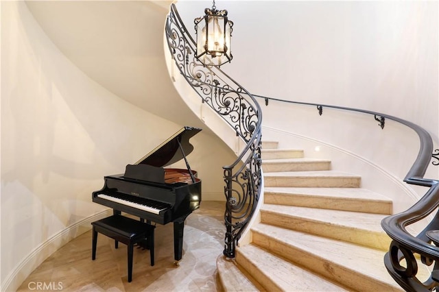 stairs with a chandelier