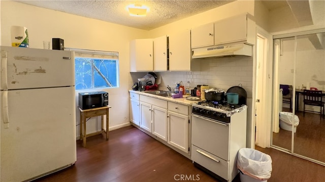 kitchen featuring dark wood-type flooring, white cabinets, custom range hood, backsplash, and white appliances