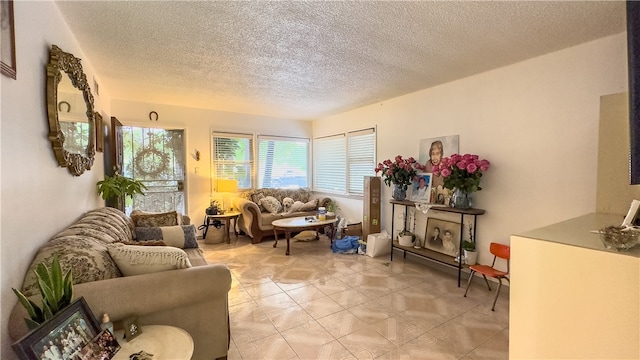 living room featuring a textured ceiling and light tile floors