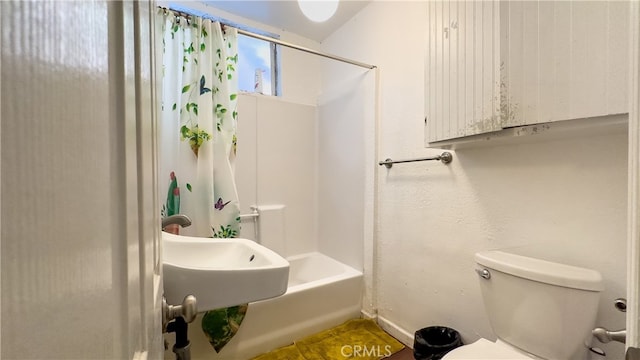 bathroom with toilet, shower / tub combo with curtain, and tile flooring