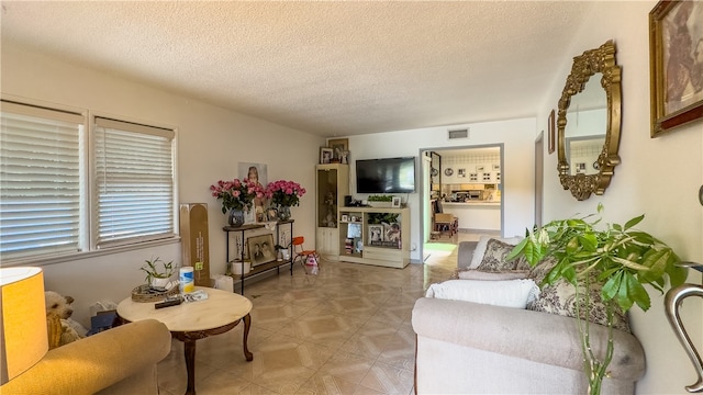 tiled living room with a textured ceiling