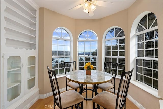 dining room with hardwood / wood-style floors and ceiling fan