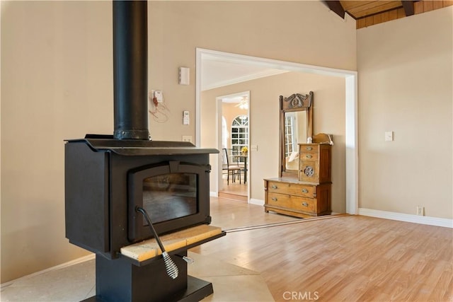 room details featuring a wood stove, crown molding, and hardwood / wood-style floors