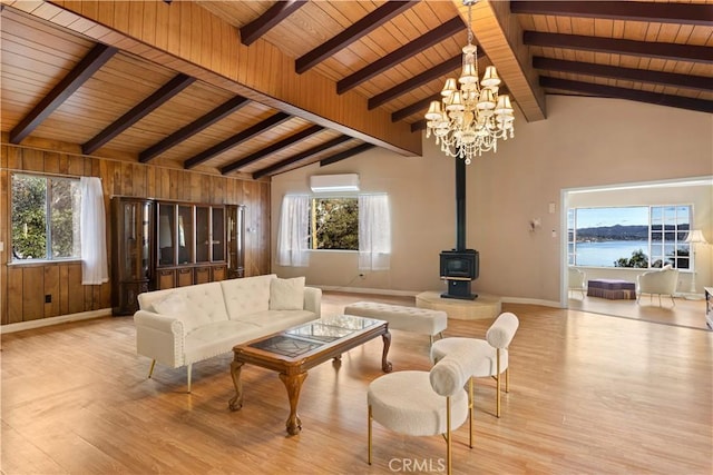 living room featuring a wall mounted air conditioner, a wood stove, an inviting chandelier, light wood-type flooring, and wood ceiling