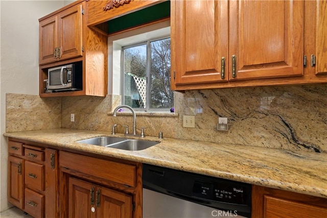 kitchen featuring decorative backsplash, appliances with stainless steel finishes, light stone counters, and sink